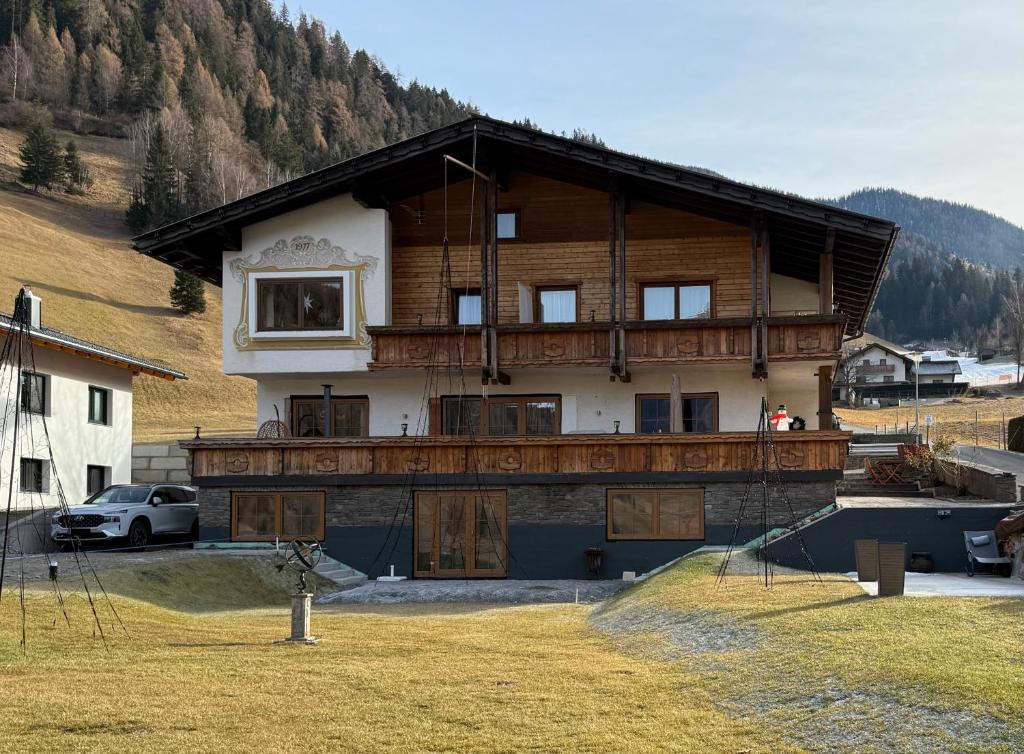 a large house with a balcony on top of it at Haus RuHe in Döllach