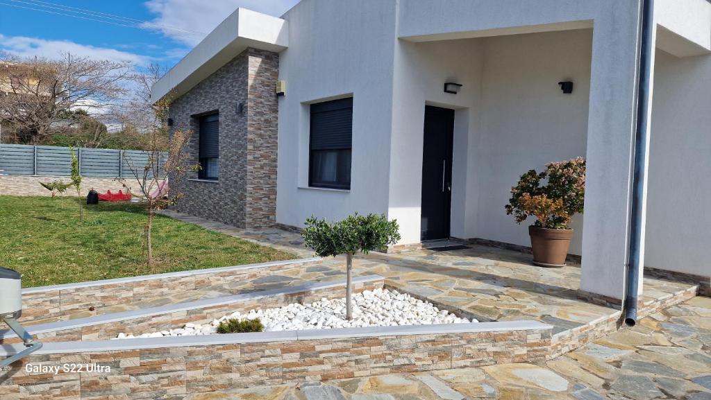 a house with a stone walkway in front of it at Villa Sofia in Kalives Poligirou