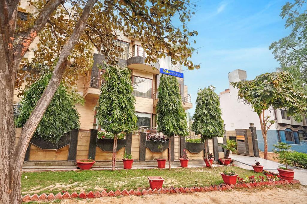 a building with potted plants in front of it at FabHotel Smart Inn-1 in Gurgaon