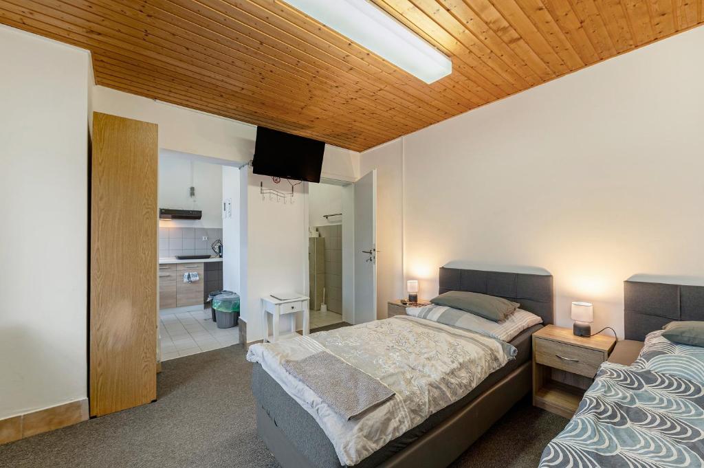 a bedroom with a large bed and a bathroom at 2 Bett Apartment a d A8 - W5 in Beckingen