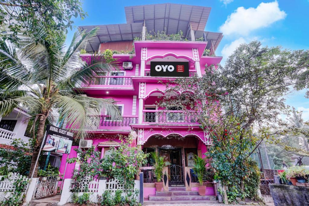 a pink building with a sign on it at Hotel O Kunal guest house in Goa