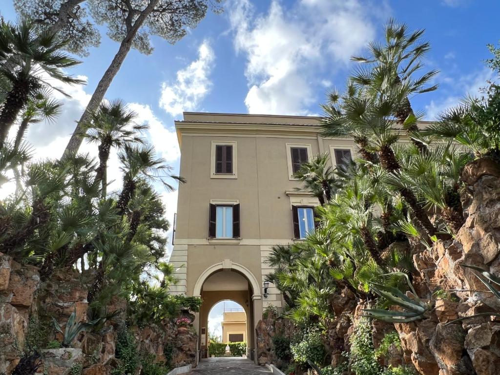 a building with palm trees in front of it at Villa Angelina in Rome