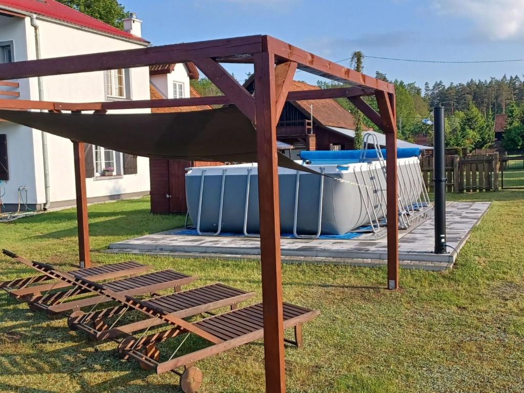 a swing set in a yard next to a pool at Apartment by Interhome in Łukta