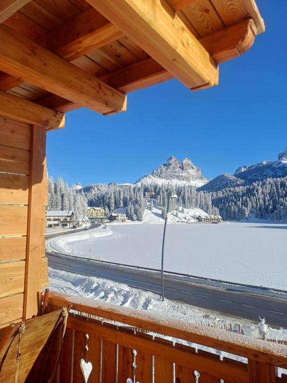 a view from the balcony of a cabin with a view of a lake at Alla Vecchia Dogana in Misurina