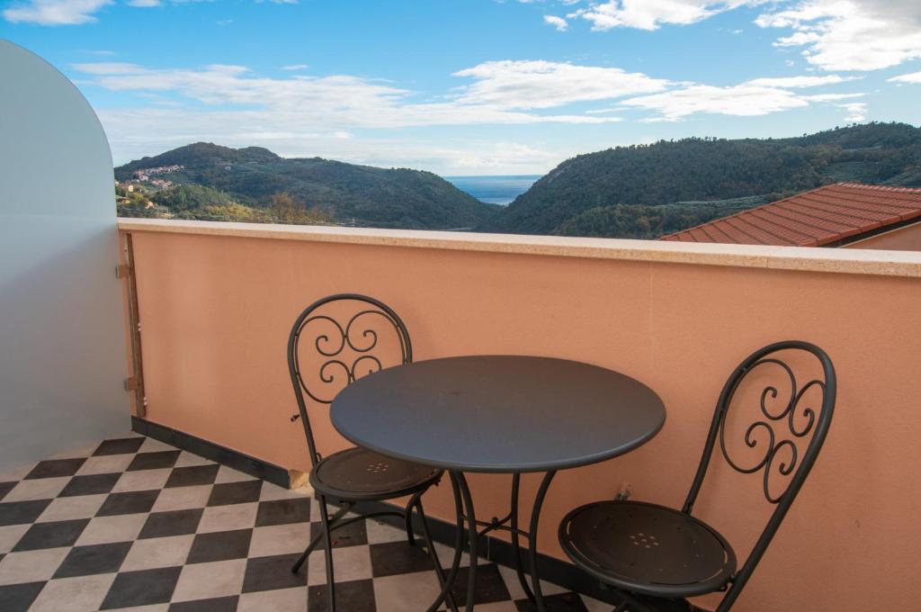 a table and chairs on a balcony with a view at Locanda Mirei in Finale Ligure