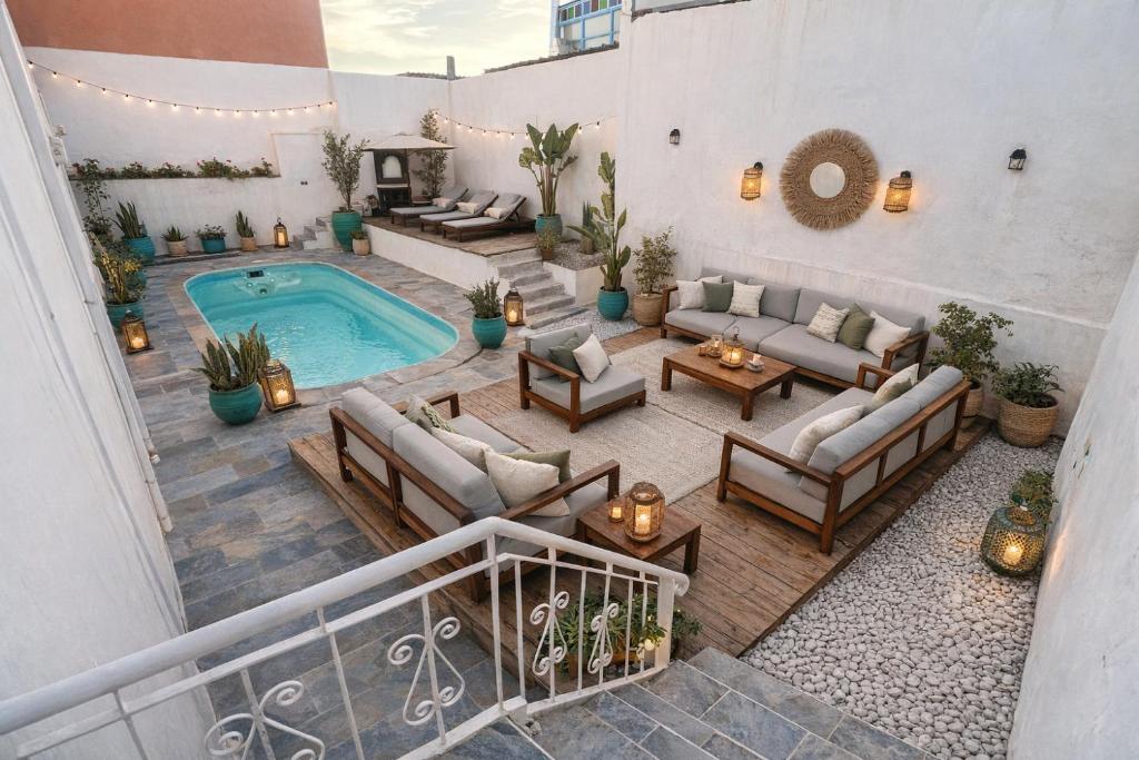an overhead view of a patio with a swimming pool at Dar Surfana Surf Camp & Yoga Tamraght in Aourir