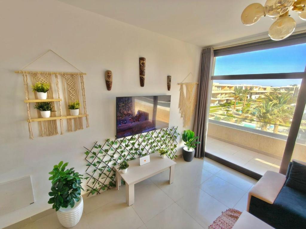 a living room with a view of the ocean at View Pool Apartment, Two Rooms in El Gouna