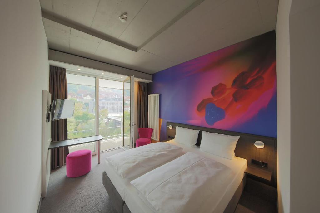 Un pat sau paturi într-o cameră la qubixx stadtmittehotel
