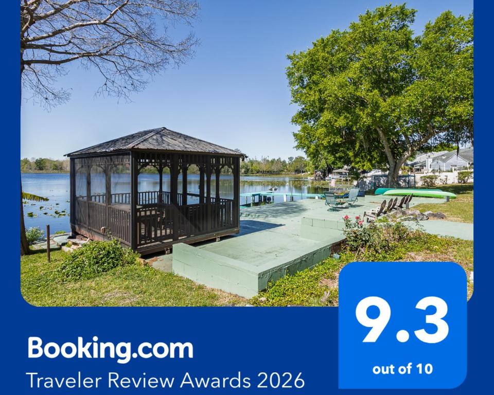 a gazebo next to a body of water at Lakefront Retreat - Boat - Fish - Close to all Orlando Parks - Disney - Universal - SeaWorld in Orlando