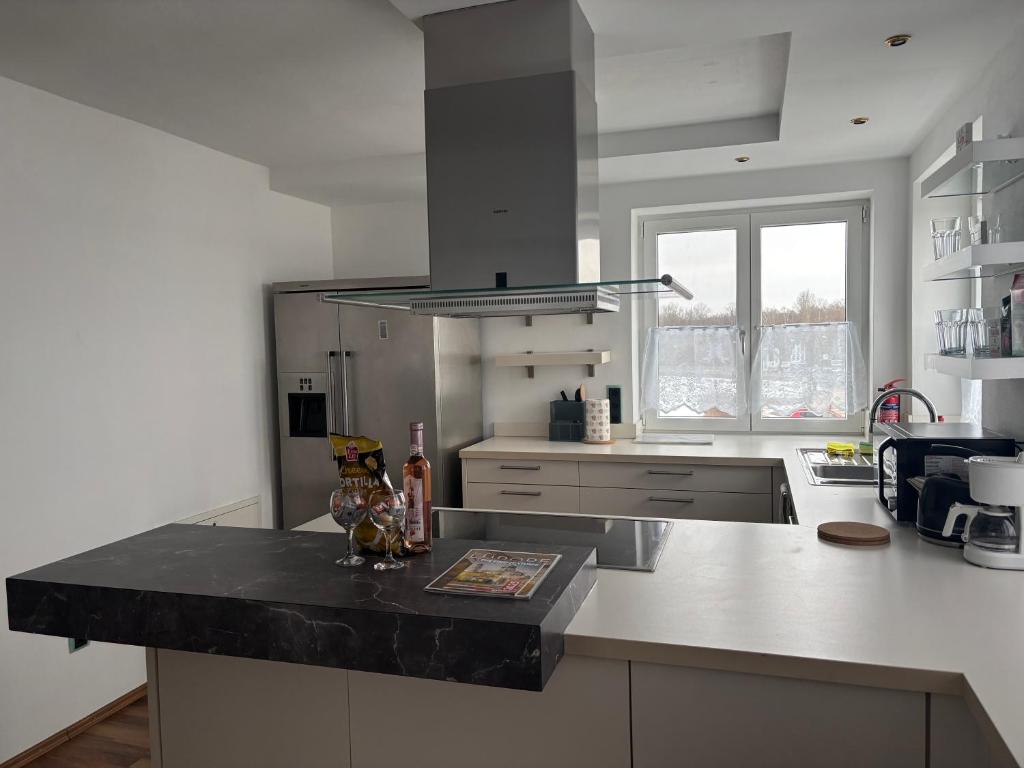 a kitchen with a black counter top and a stove at Vilseck Stay in Vilseck