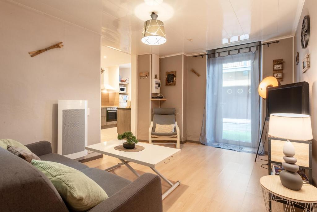 a living room with a couch and a table at Appartement T2 Les Pyrénées in Bagnères-de-Bigorre
