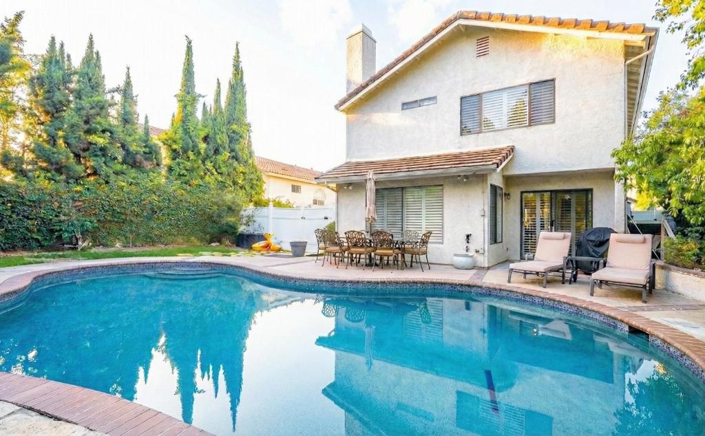a swimming pool in front of a house at Luxe 2-Story Oasis with Private Pool & Backyard in Laguna Niguel