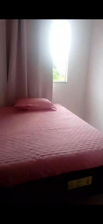 a bedroom with a bed with a red blanket and a window at Outeiro in Belém