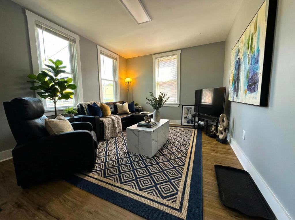 a living room with a couch and a tv at Cozy unit King bed & laundry in Wilmington