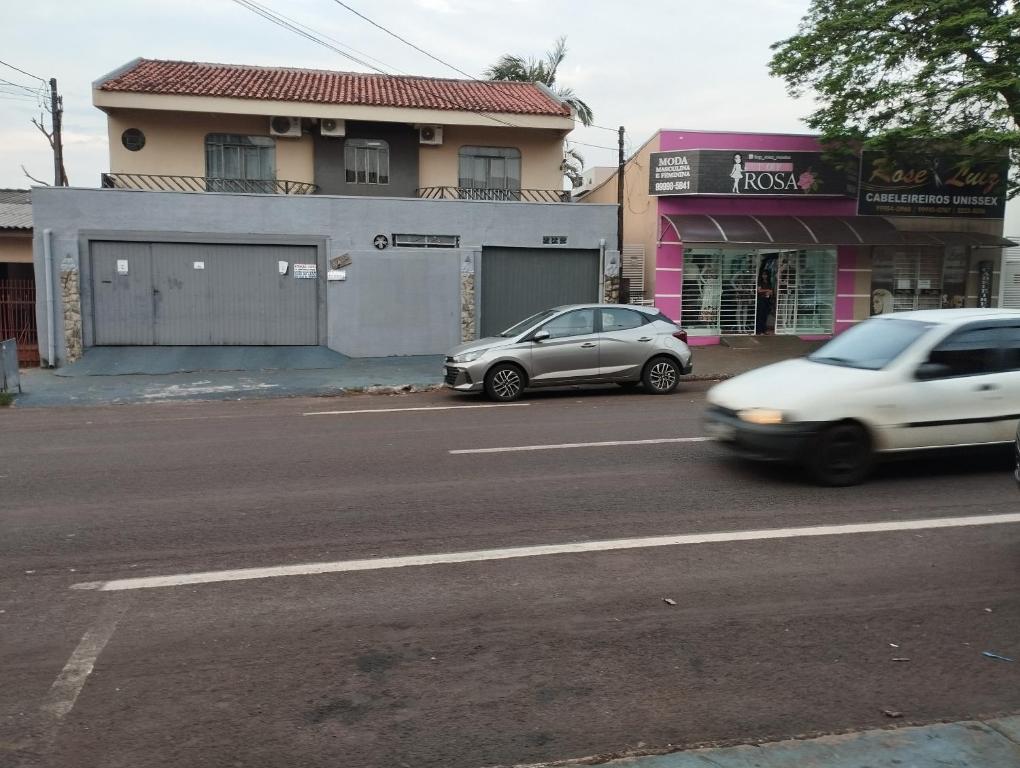 two cars parked on the side of a street at Espaço Ideal 7 in Cascavel