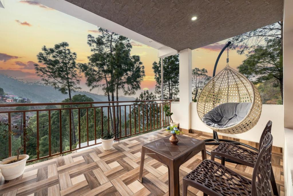 a room with a balcony with a hanging swing at The Starlight Hotel Kasauli by Splendid Retreat Hotels in Kasauli
