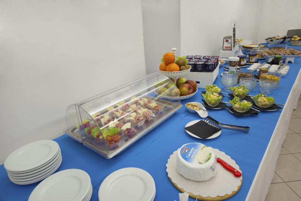 a blue table with a buffet of food on it at Hotel del Mar in Sottomarina