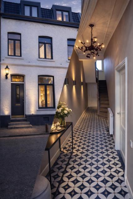 a hallway leading to a house with a chandelier at B&B Saint Pierre in Maastricht