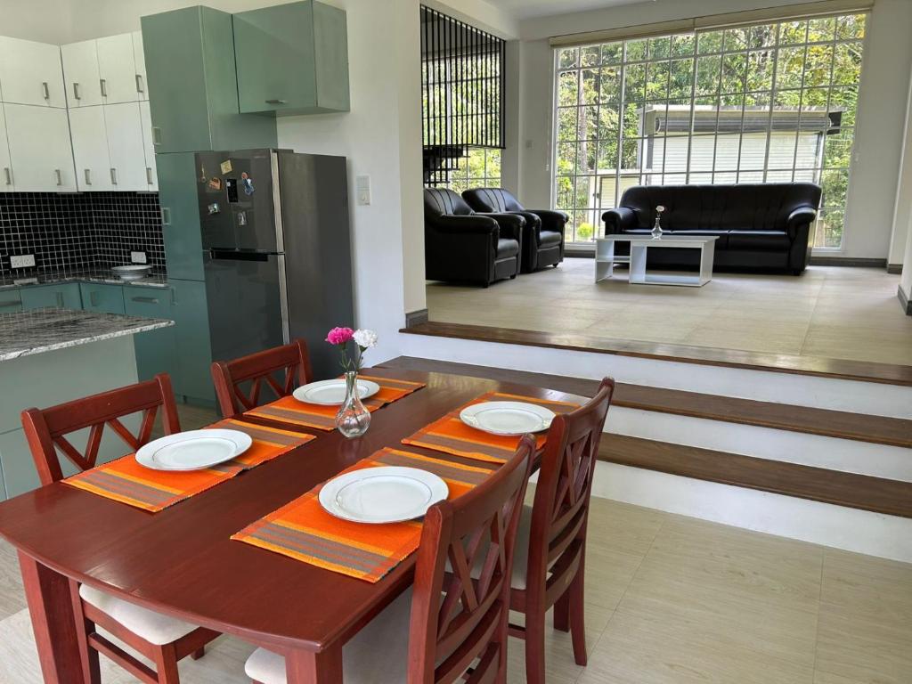 a kitchen and dining room with a table and chairs at Hillkandy in Kengalla