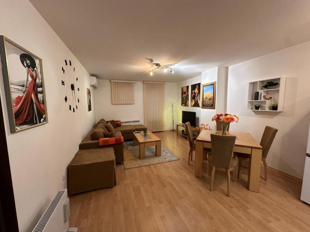 a living room with a couch and a table at Borealis Apartment in Bansko