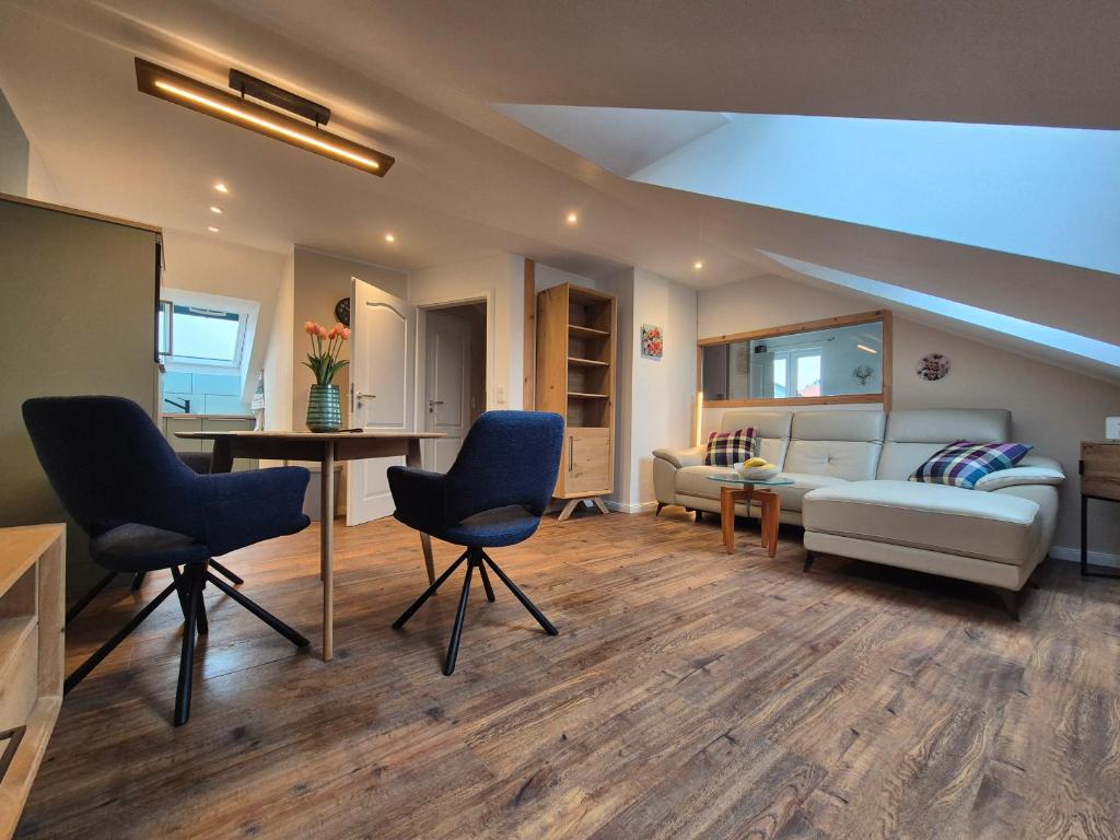 a living room with a couch and a table and chairs at # Ausblick LübEck in Lübeck