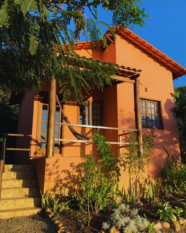 a house with stairs in front of it at Pousada Jardim da Vida in Palmeiras