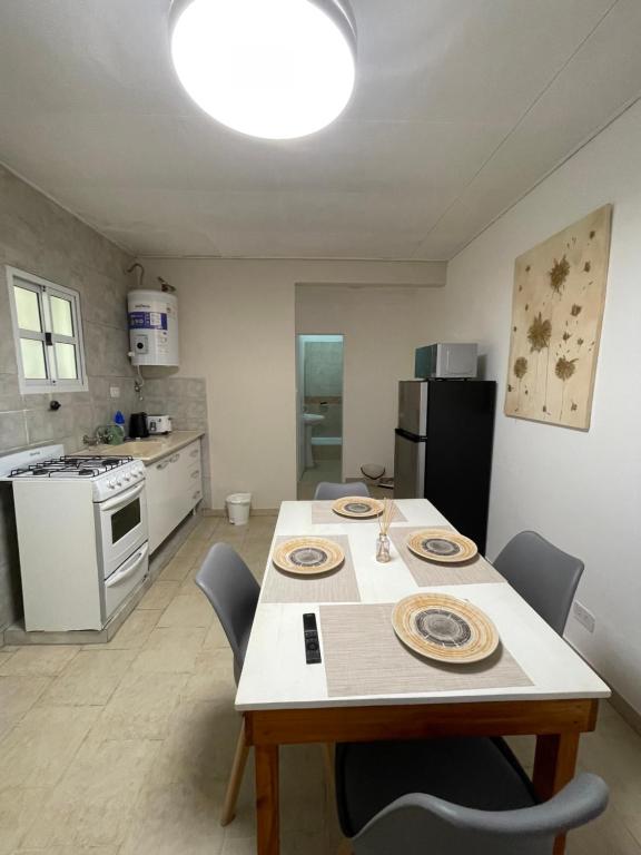 a kitchen with a table and chairs in a room at Cabaña 36 termas in Chajarí