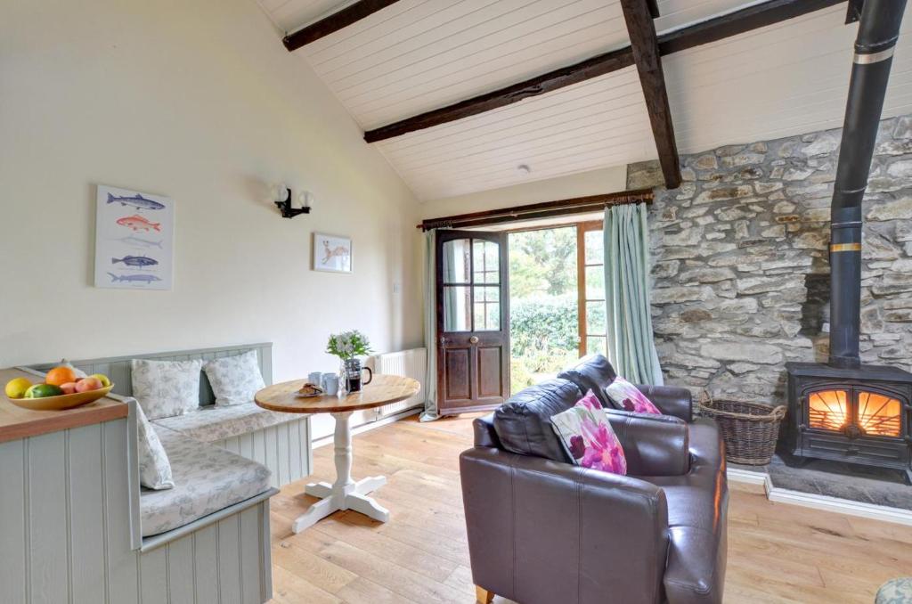 a living room with a couch and a fireplace at 2 Bed in Carmel oc-wai211 in Llanerchymedd