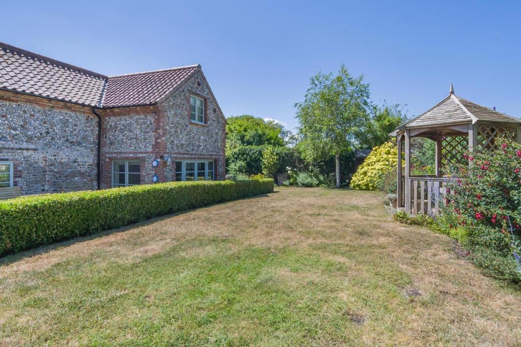 an old stone house with a garden and a gazebo at 3 Bed in Cley oc-t32433 in Cley next the Sea