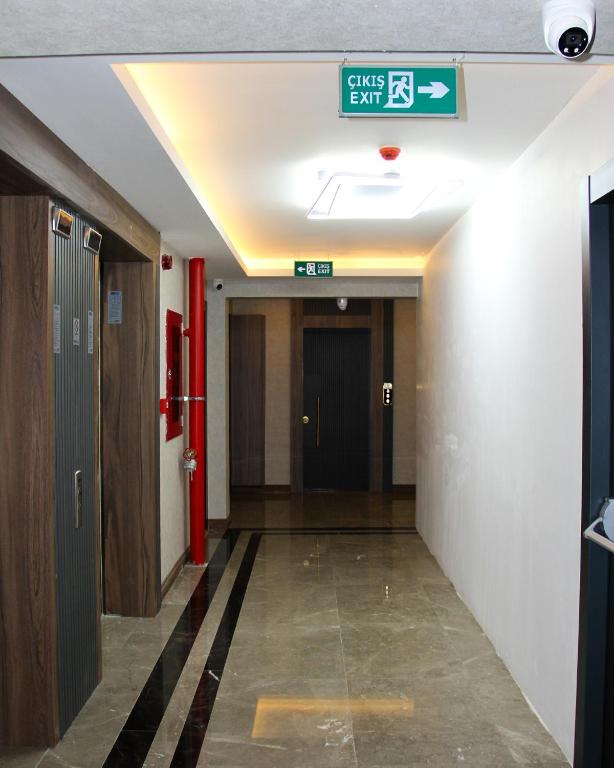 a hallway with a exit sign in a building at Viva Nova Suit Hotel in Bakanlıklar