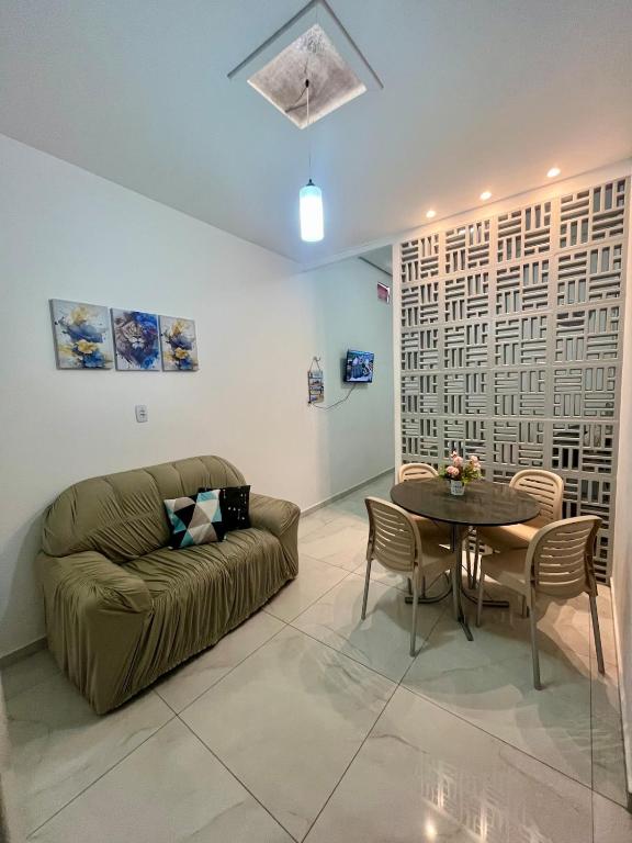 a living room with a couch and a table at Studio - Serraruna in Araruna