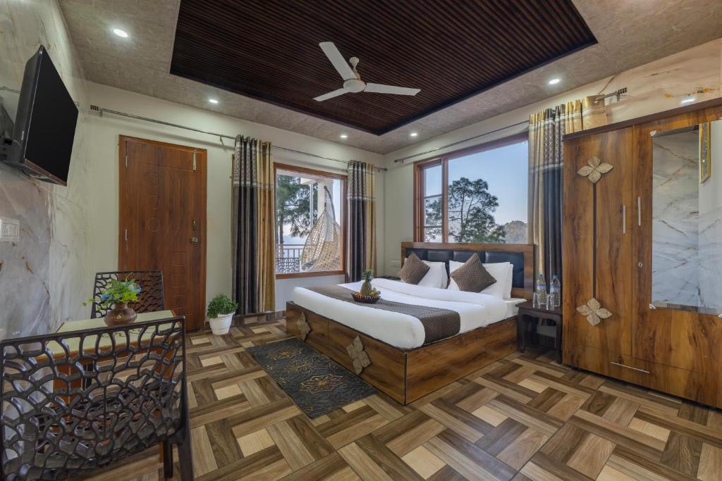 a bedroom with a bed and a ceiling fan at The Hills Station Nest - 4 Bedroom Villa by Splendid Retreat Hotels in Kasauli