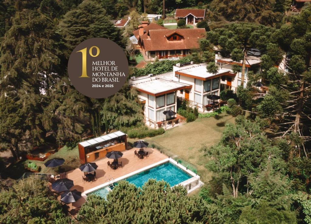 an aerial view of a house with a swimming pool at Hotel Boutique QUEBRA-NOZ in Campos do Jordão