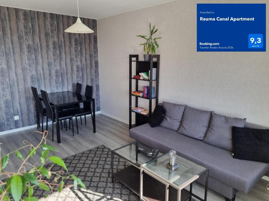 a living room with a couch and a table at Rauma Canal Apartment in Rauma