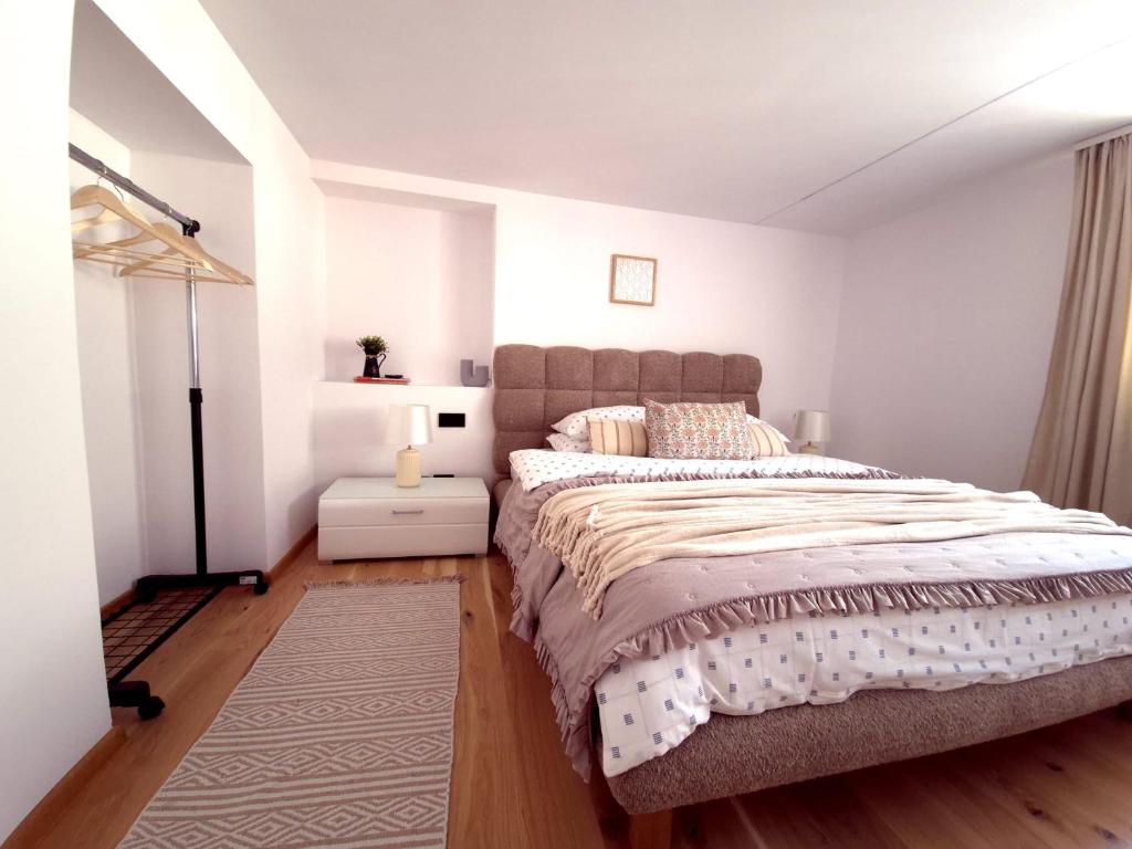 a bedroom with a large bed in a white room at Vamesu Frontiers - Luxury borders in Sibiu