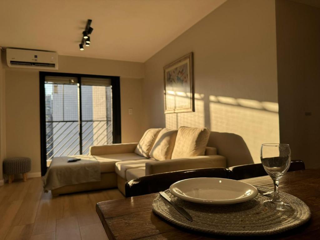a living room with a couch and a table at En el Corazón de Rosario in Rosario