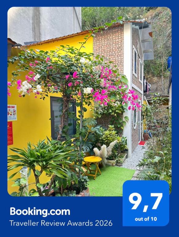 a yellow house with a bunch of flowers on it at ỐC Homestay Cat Ba in Cat Ba