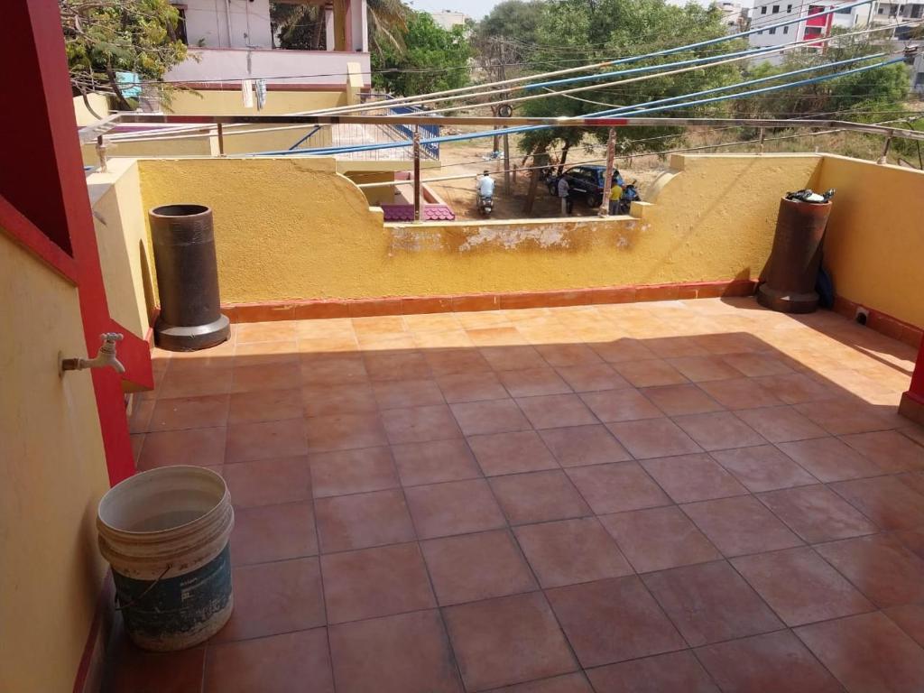 an open door to a balcony with a tile floor at Saraswati Sadan in Hospet