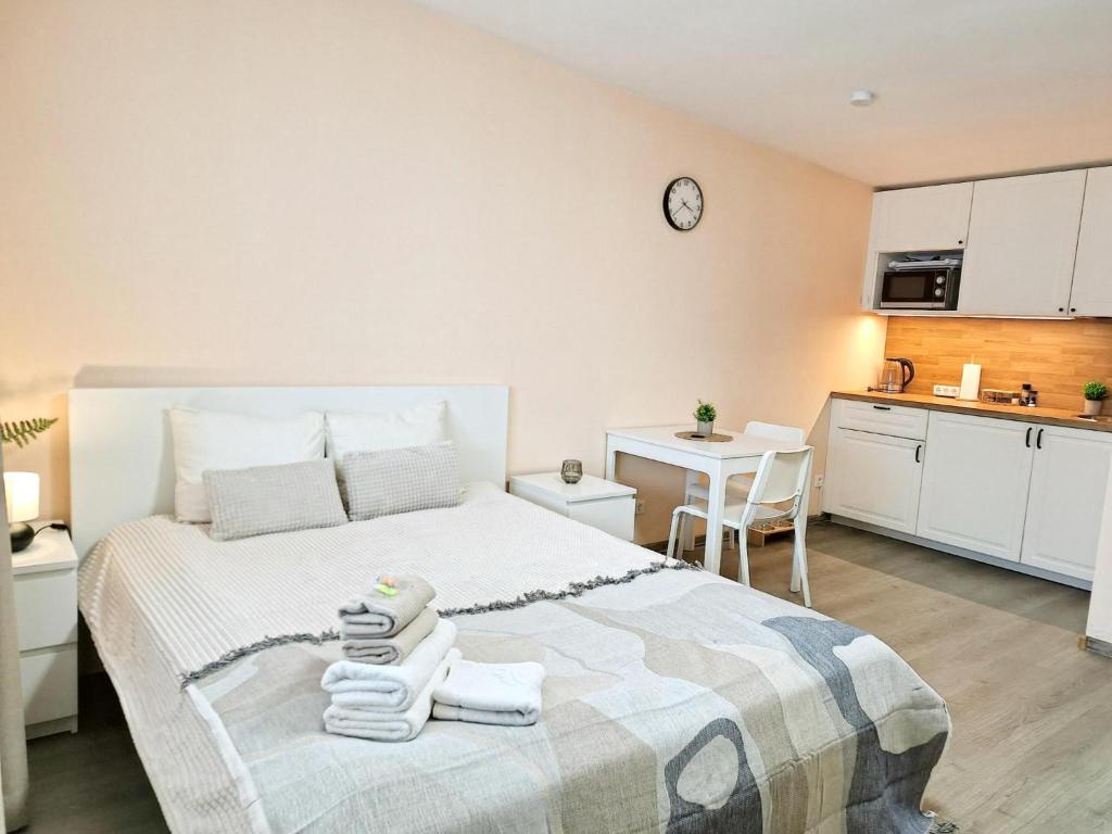 a bedroom with a bed with towels on it at Dunes Trail 3 in Melnragė