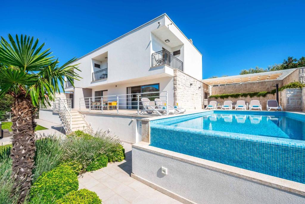 an image of a house with a swimming pool at Villa High Life in Seget Vranjica