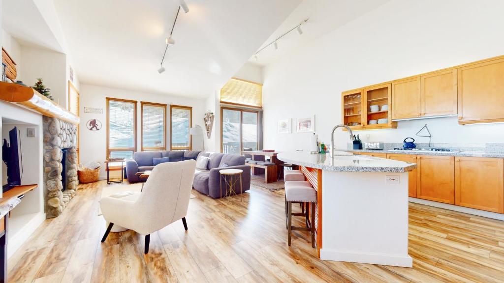 a kitchen and living room with a counter and chairs at Snowcreek V #777 in Mammoth Lakes