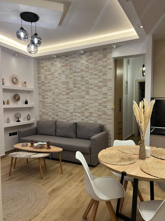 a living room with a couch and a table at Via Basta in Koroni