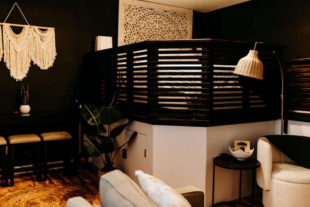 a living room with black walls and a couch at Sol Sage Studio Downtown in Wilmington