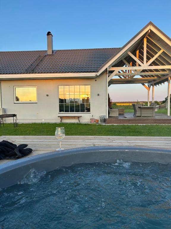 a swimming pool in front of a house at Nice getaway, 20 min from Tallinn in Järsi