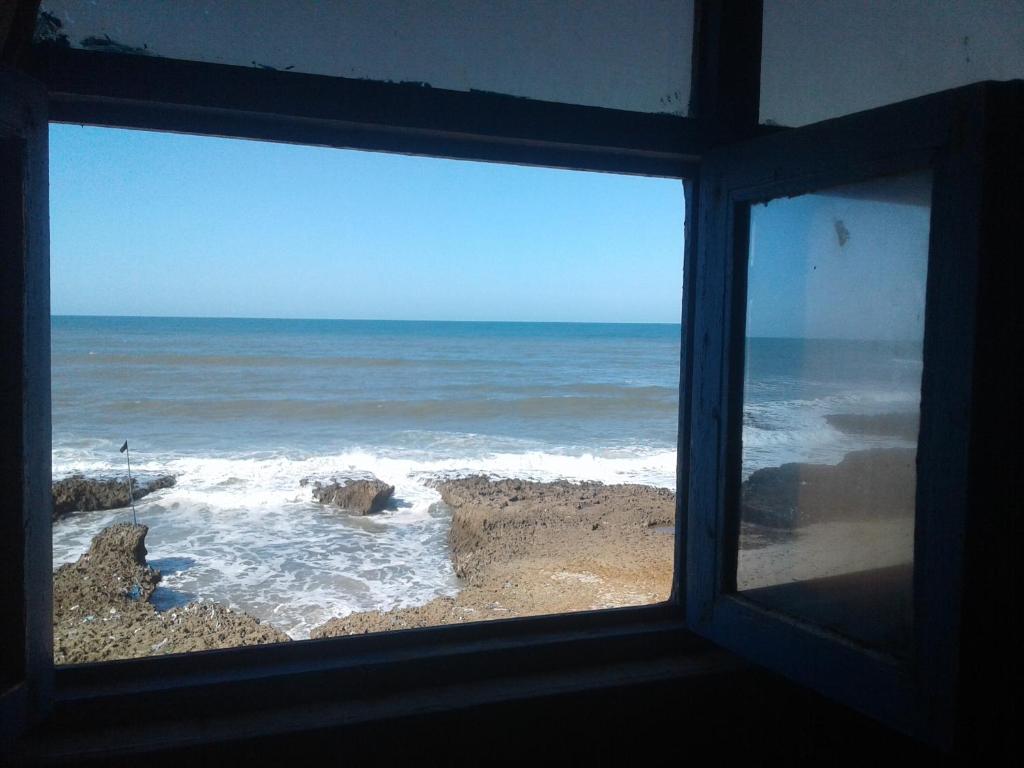 a view of the ocean from a window at Grotte Panoramique Atlantique d'Aglou in Zaouia Sidi Ouaggag