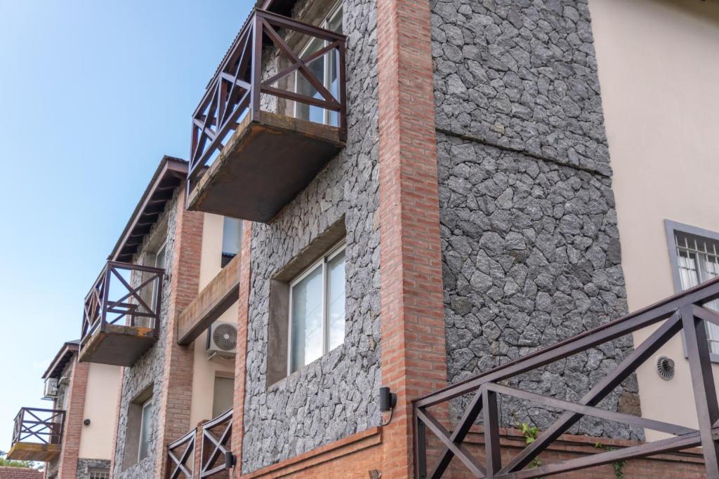 a building with two balconies on the side of it at Tangerina Apart Hotel - Villa Gesell in Villa Gesell