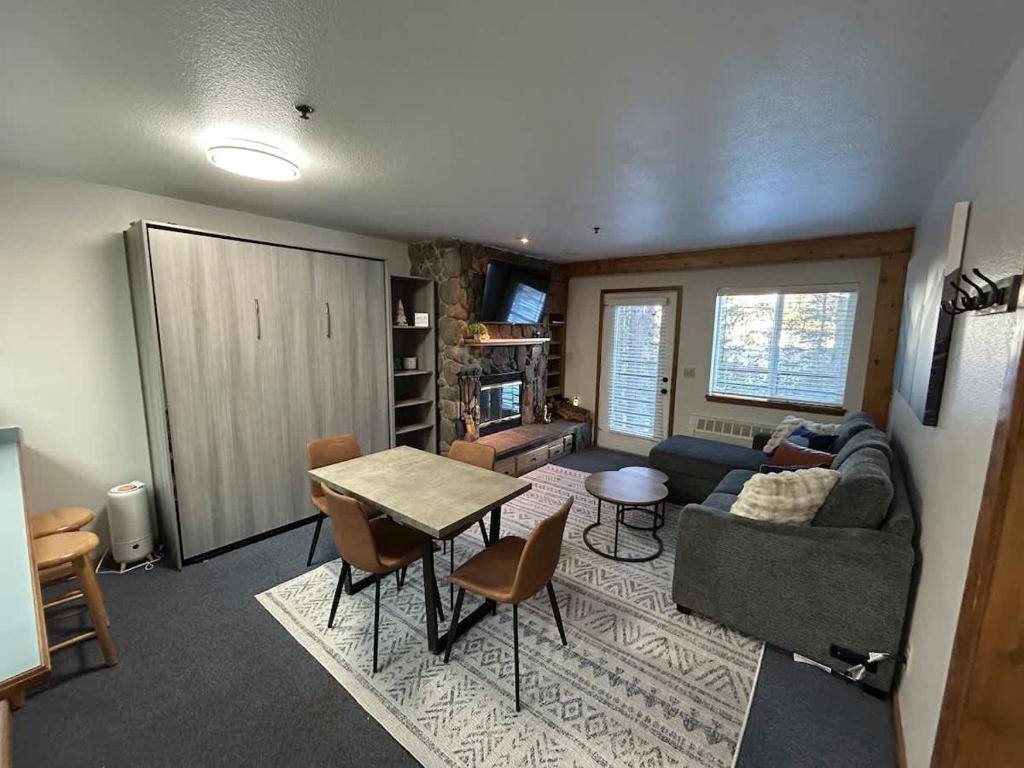 a living room with a couch and a table at The Meadows- Charming 1BD2BA Ski Condo in Kirkwood