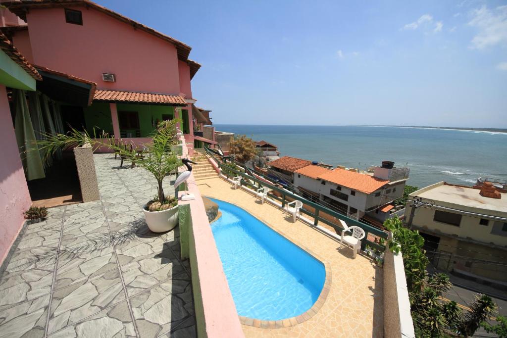 an image of a swimming pool on a balcony of a building at Pousada do Sergio in Barra de Guaratiba