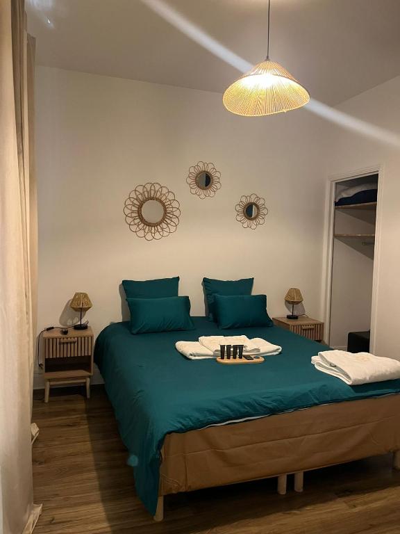 a bedroom with a green bed with a tray on it at Les Sources Vichy in Vichy