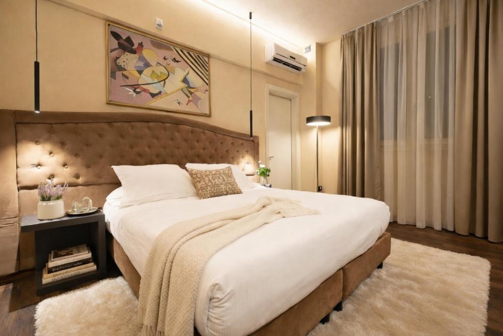 a bedroom with a large bed with a blanket on it at Hotel Ristorante Ala d'Oro in Lugo
